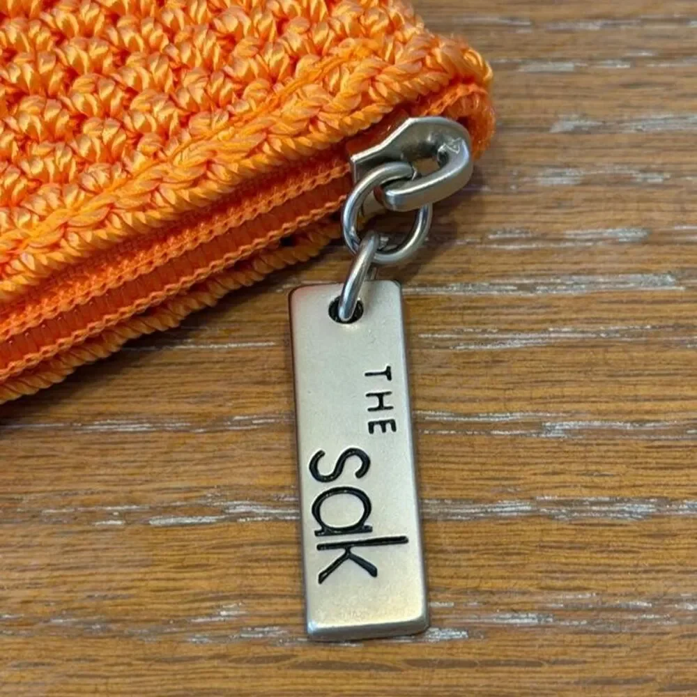 The Sak Crochet Orange Cosmetic Pouch Bag